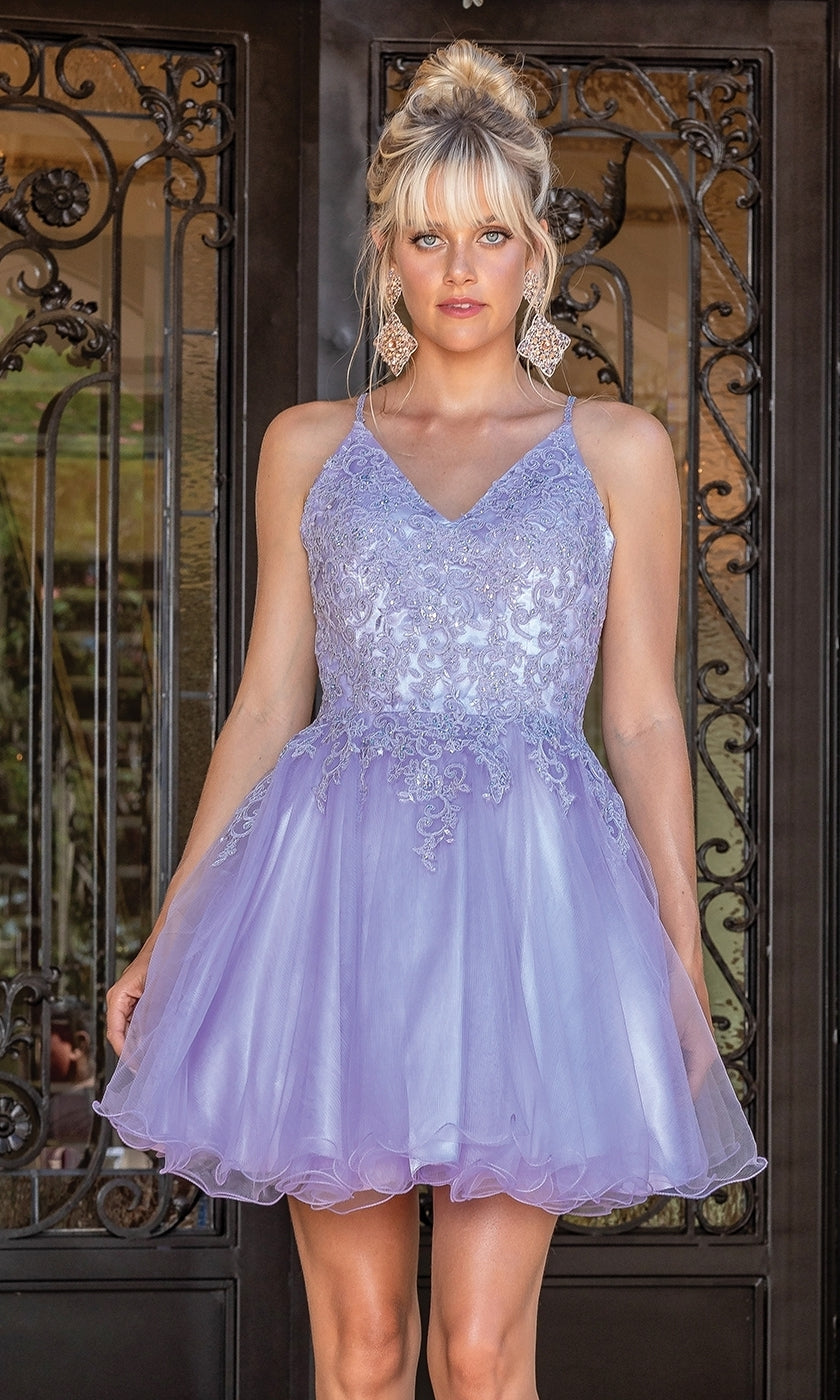 A woman stands before ornate black doors wearing the Lace-Up Short Babydoll Homecoming Dress 3303, a light purple A-line party dress with a corset bodice, lace detailing, and tulle accents.